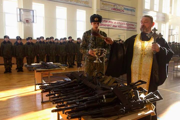Priest blessing guns
