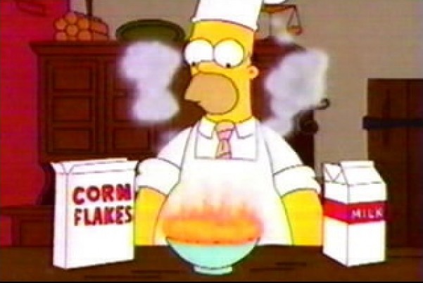 Homer Simpson cooking, and managing to burn cornflakes